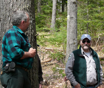 Logger Will Cole converses with MFS District Forester Gordon Moore